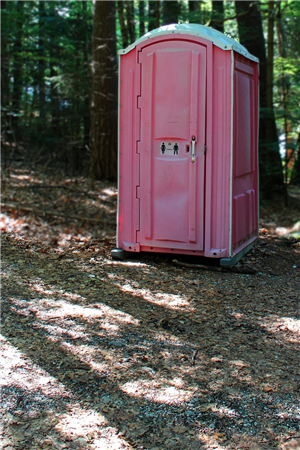 Pink portable toilet set up on site